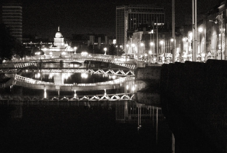 a view of a city at night with lights reflecting in the water