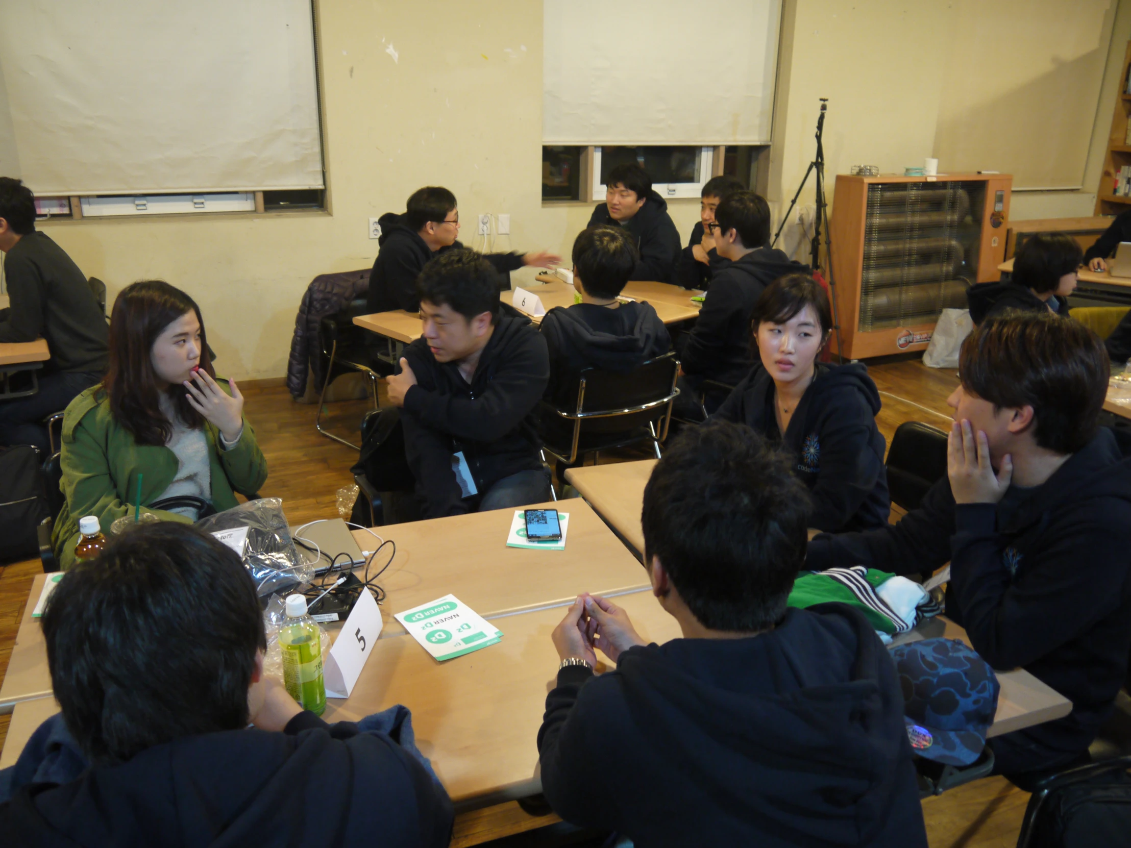 there are several people sitting around each other eating