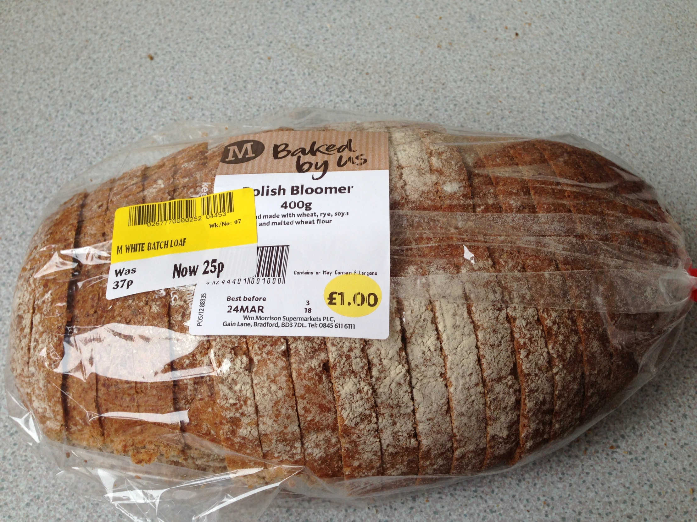 a loaf of fresh bread sits wrapped in plastic