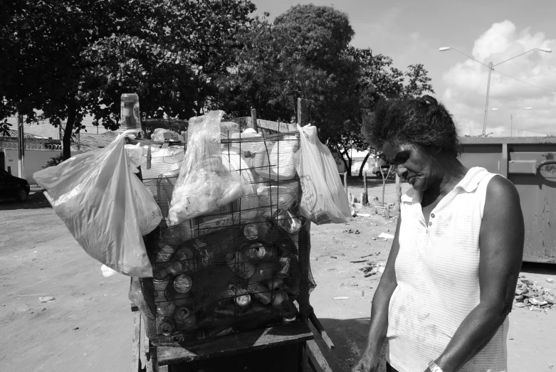 the lady is next to her produce cart