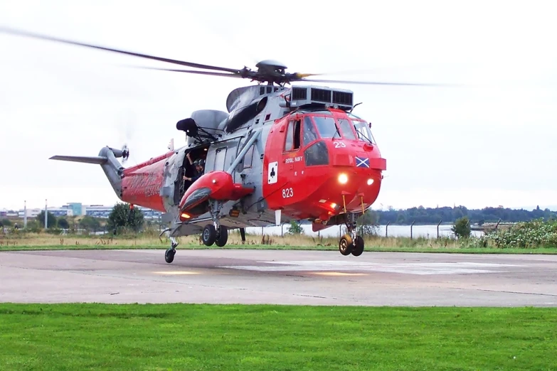 a helicopter flying over a runway on a field