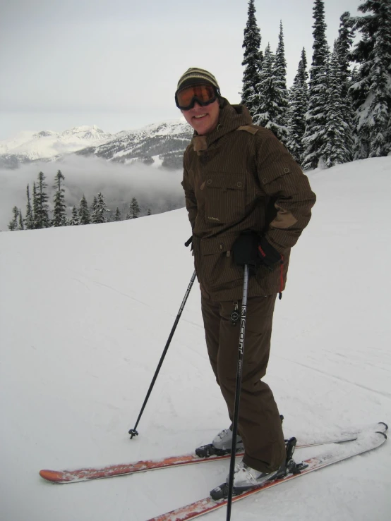 a woman standing on skis on top of a snowy slope