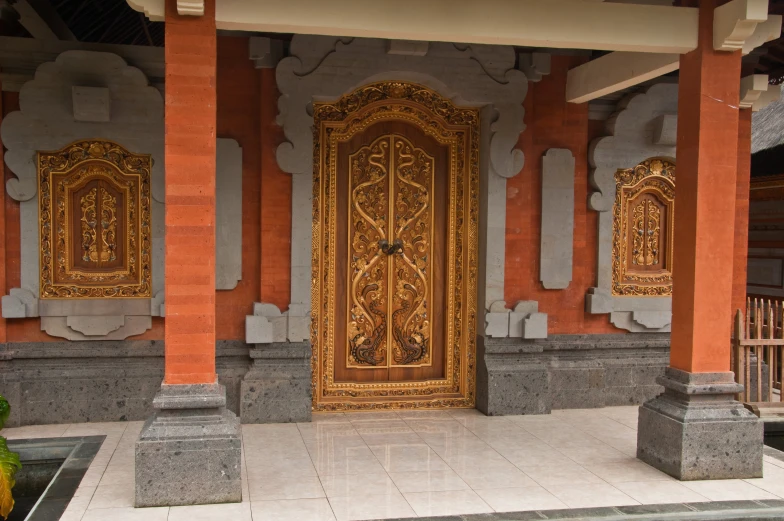 an ornate doorway to a building with orange walls