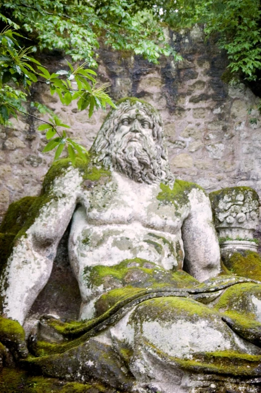 the statue has  on but his is covered in green moss