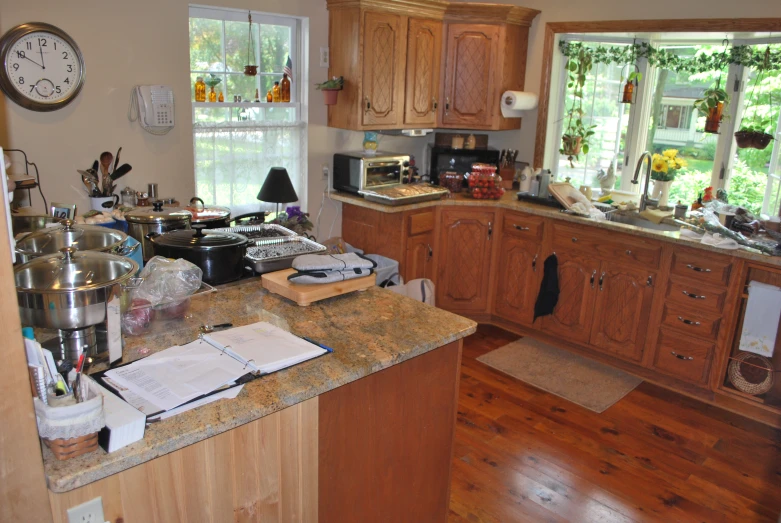 a kitchen filled with lots of clutter on top of a counter