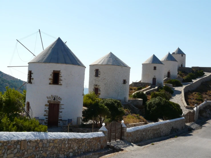 several white stone buildings with a sky background