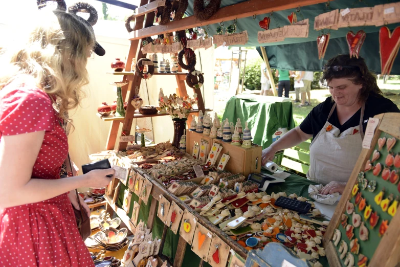 a woman in red and white dress looking at candy