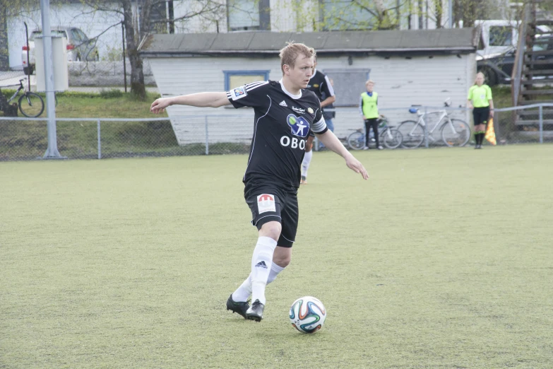 a young man is kicking a soccer ball in a game