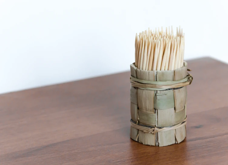 there is an old bamboo basket full of matches