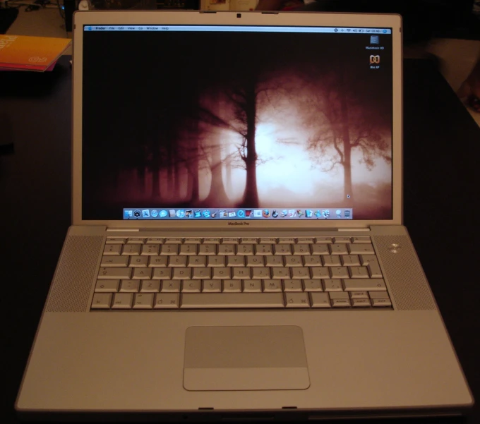 a laptop computer sitting on top of a wooden table