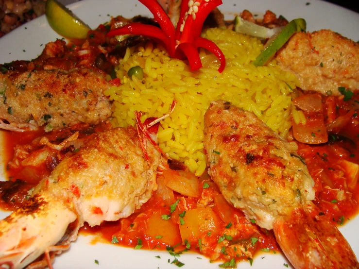 the plate contains shrimp, rice and other vegetables