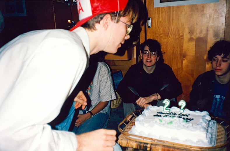 the boy is blowing out candles on the cake