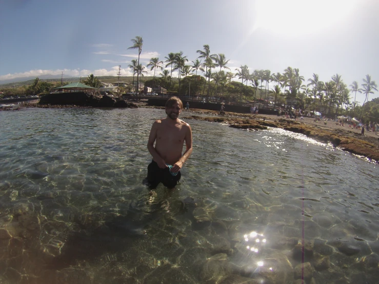 a man standing in the water of an ocean