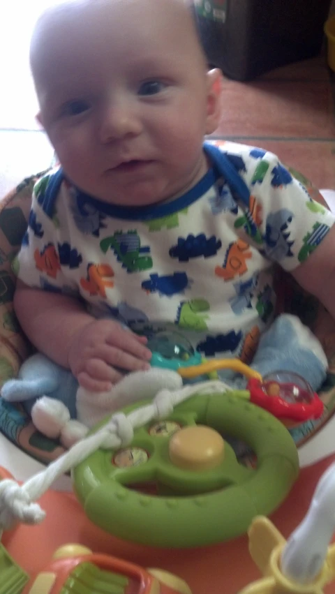 a toddler is sitting in his high chair