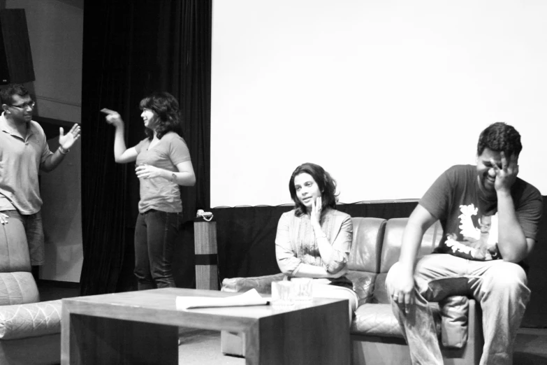 a man and woman sitting on a couch next to each other