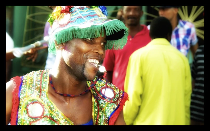 a man with some kind of hat in his mouth