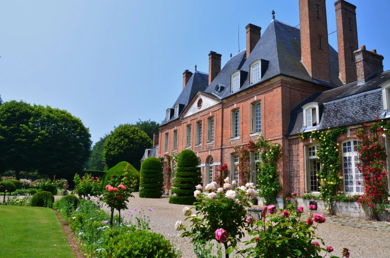 an image of beautiful house with rose garden