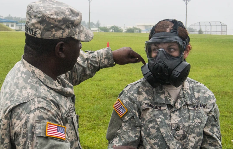 a man wearing a face mask is next to a soldier