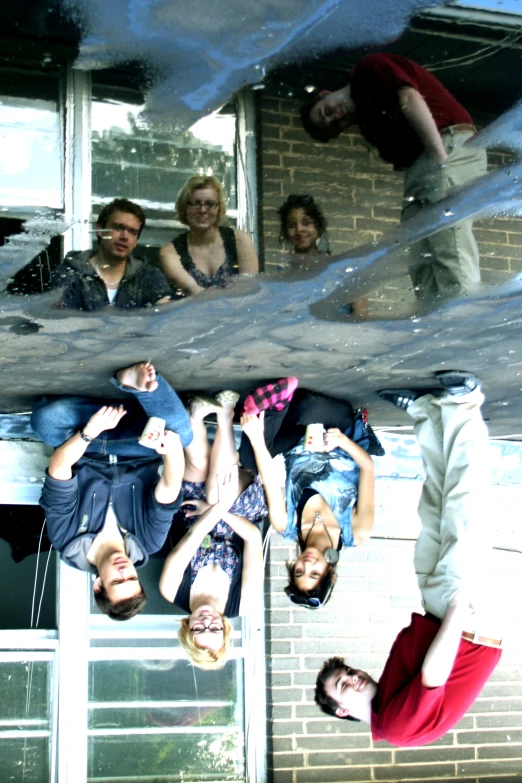 a group of people hanging upside down from the roof