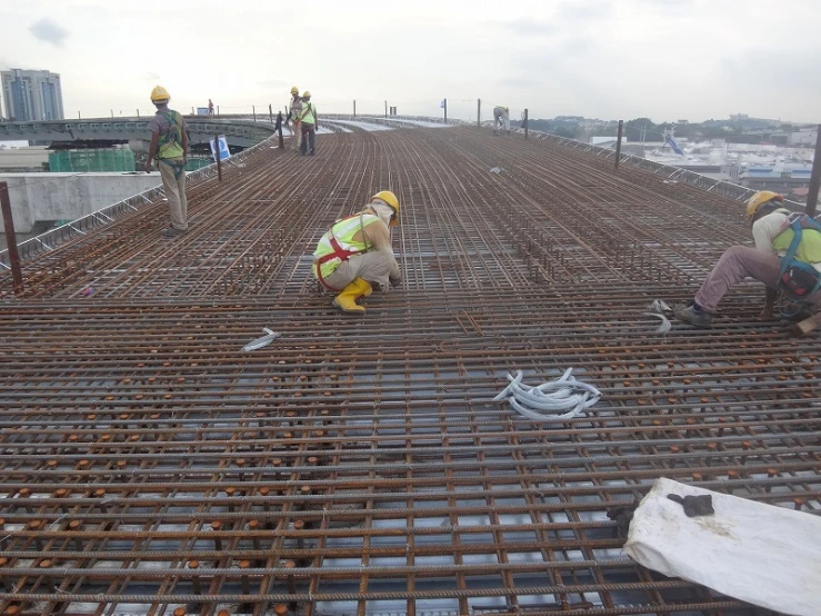 workers on a construction site pouring concrete for a new building