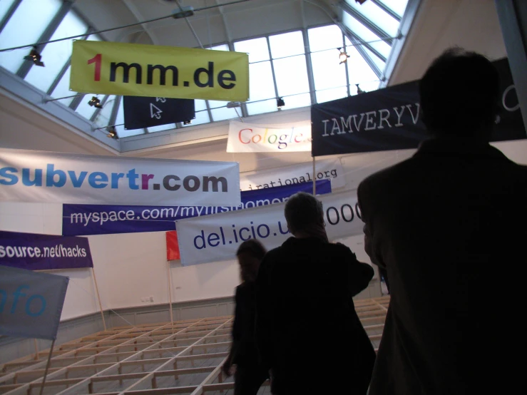 a man and a woman standing in front of a banner display