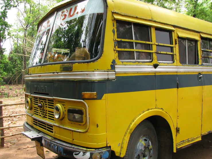 a yellow and black bus parked on a parking lot