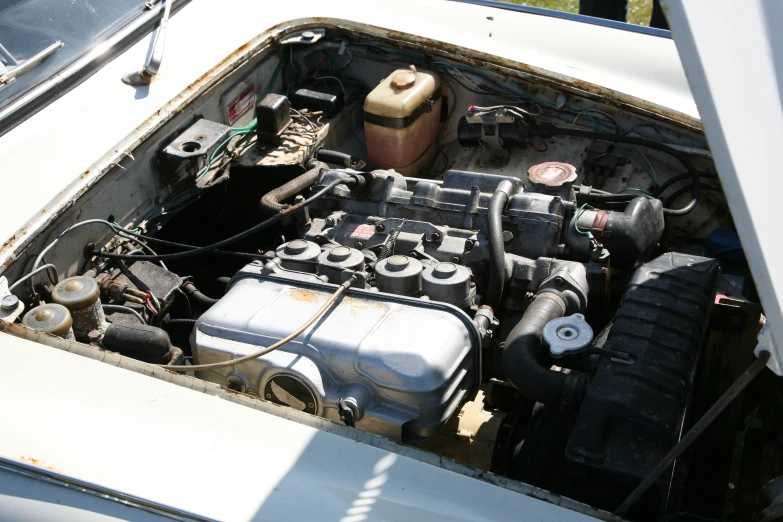 the engine compartment of an old white truck