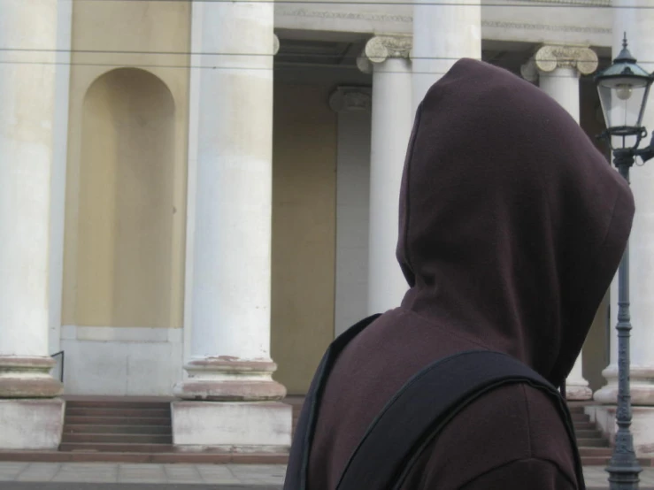 the back of a person wearing a dark colored hoodie