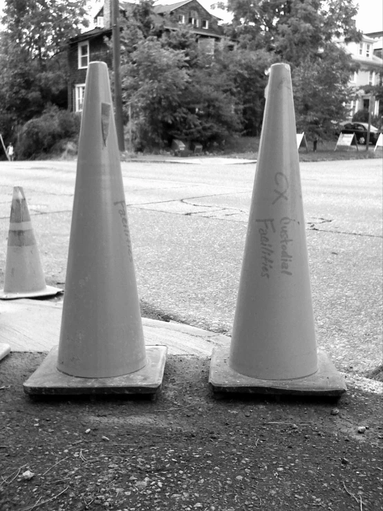 some traffic cones that are standing on the sidewalk