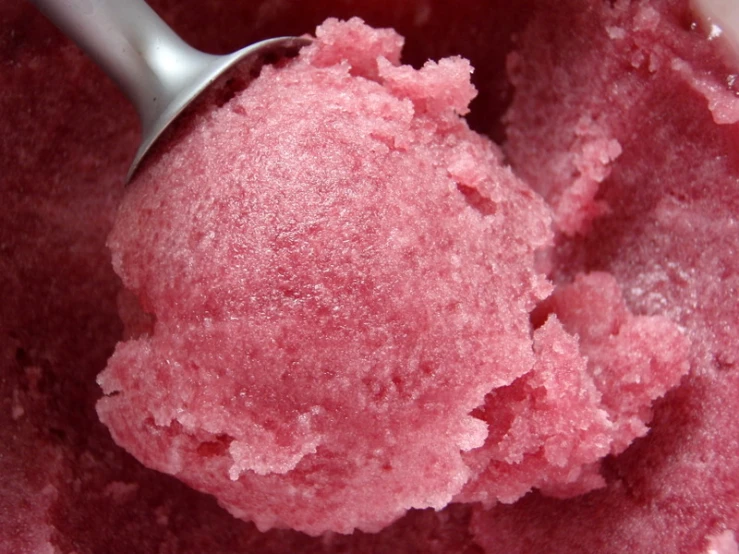 a scoop of pink ice cream in a bowl