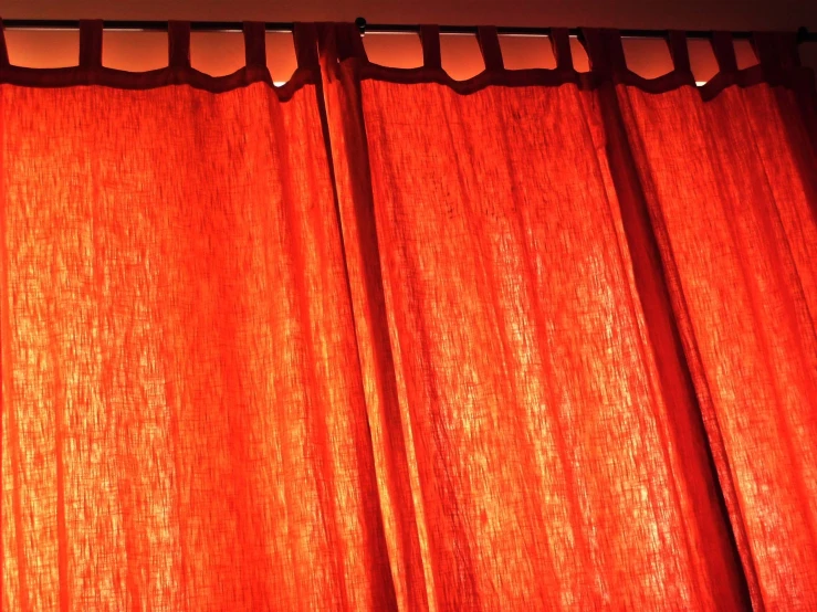 a light is on behind the curtains