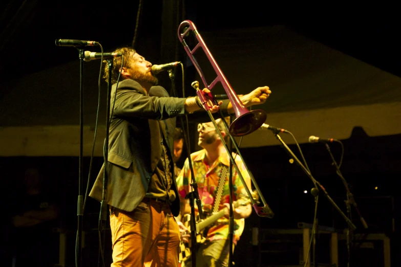 a person standing on stage holding a trumpet