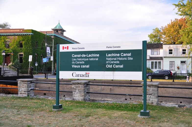 a street sign sitting beside a rail road track