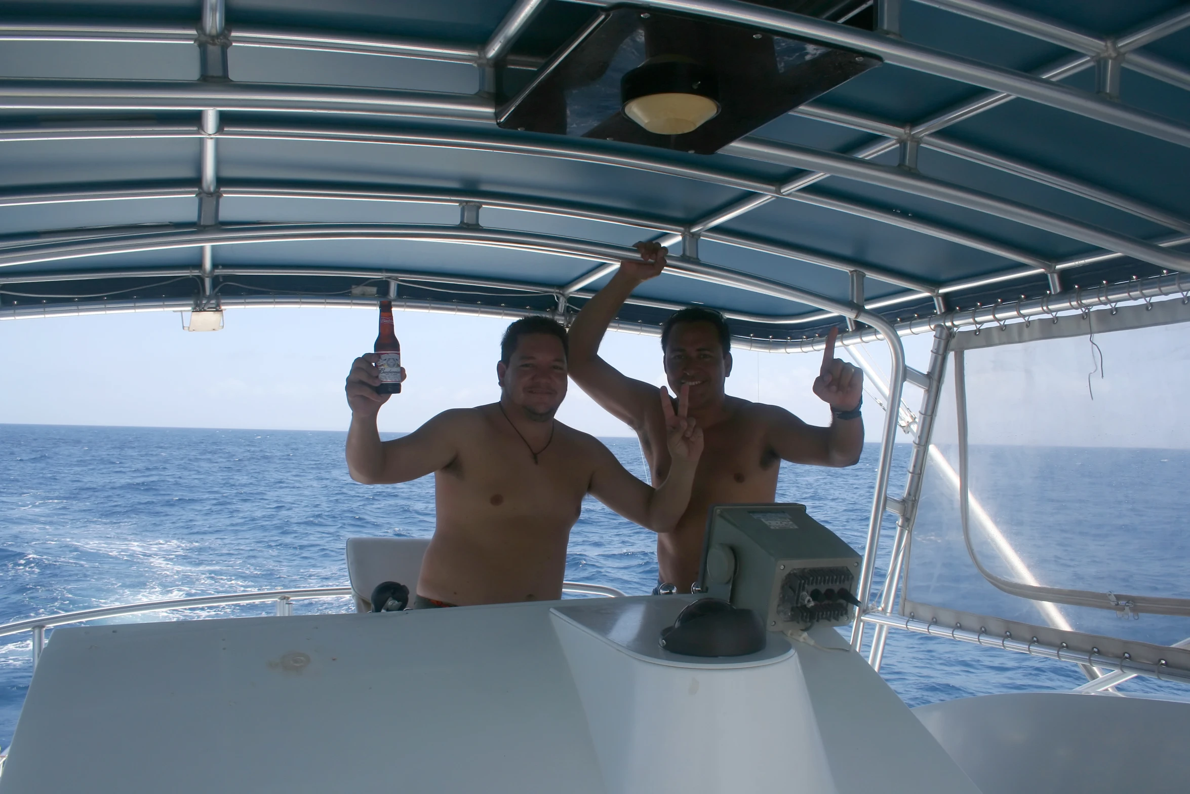 two guys are standing with beer in their hands