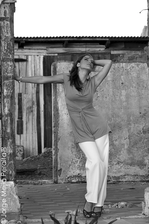 woman doing yoga exercise outdoors in front of building