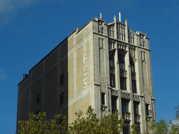 an old building is shown against a blue sky