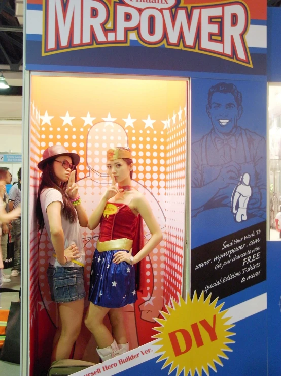 two models are dressed as wonder woman for a display
