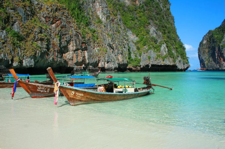 boats are on the sand near the water