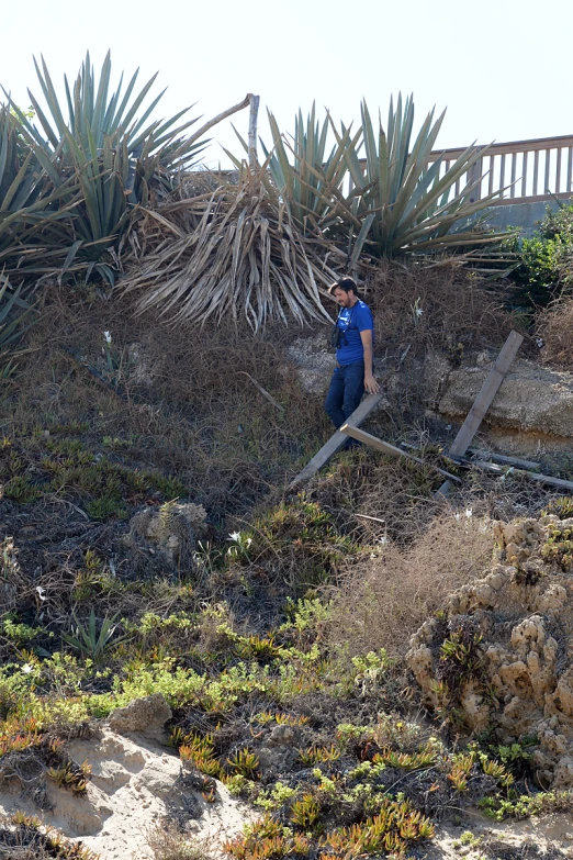 a man in blue jacket standing on a ramp