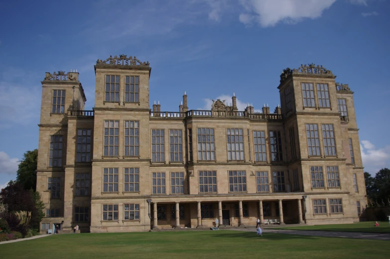 a tall, old, stone building with two balconies on top