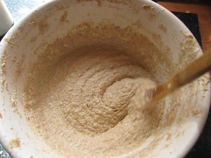 a large wooden spoon in a white bowl