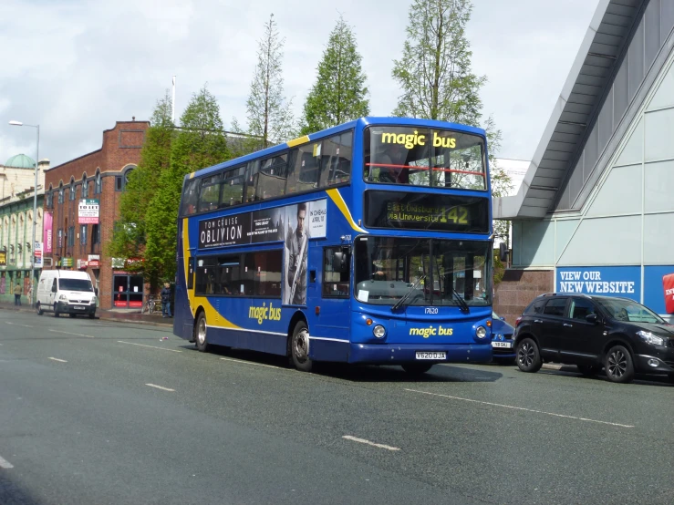 there is a double deck bus that is pulled up to the curb