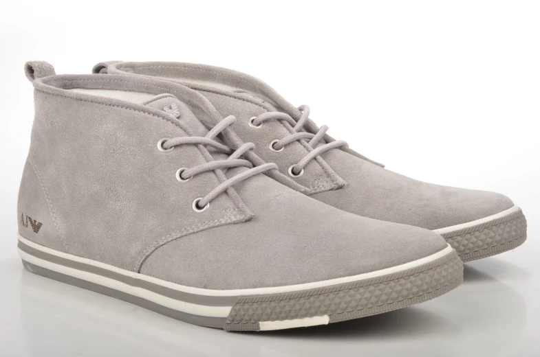 two gray sneakers with laces on top of them