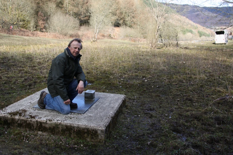 there is a man sitting on a stepping stone with soing in his hands