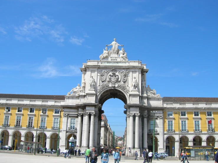 an arch and some people walking in front of a building