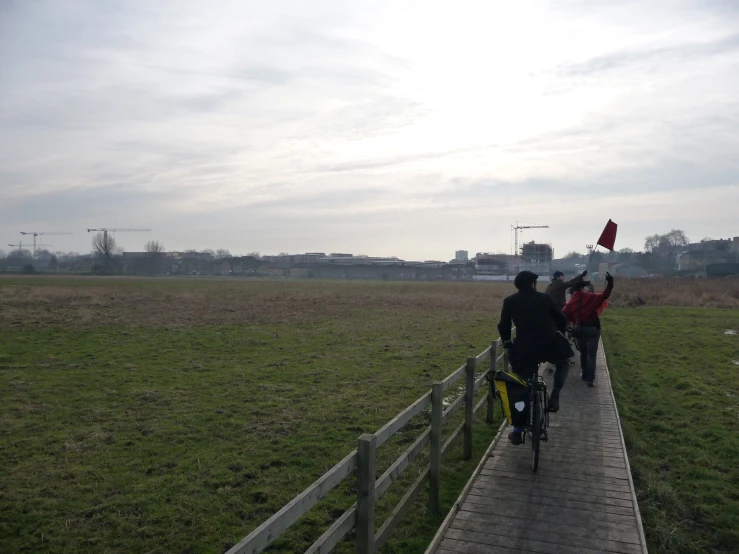 the bicyclists are going down the path together