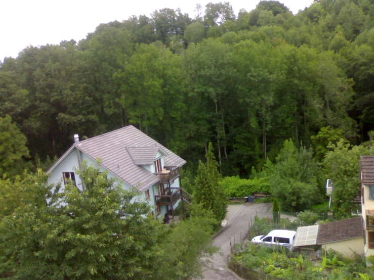 an aerial view of the house near the woods