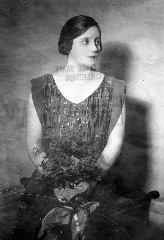 a woman in a dress holding a bouquet of flowers