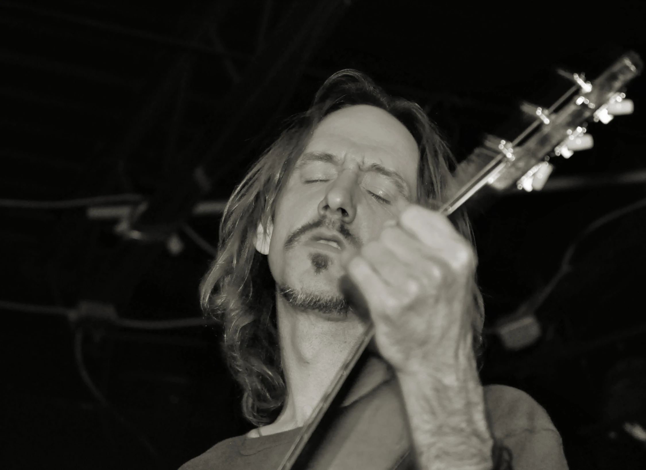 a person playing a guitar and smoking a cigarette