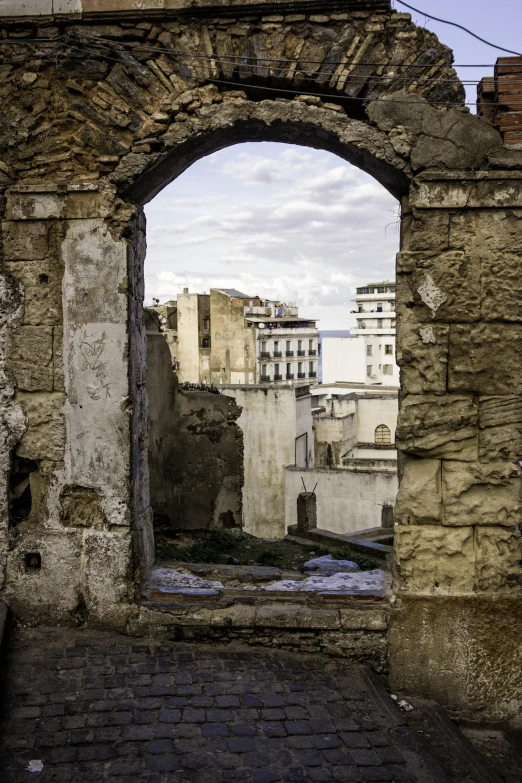 the view out the tunnel looking over an old city